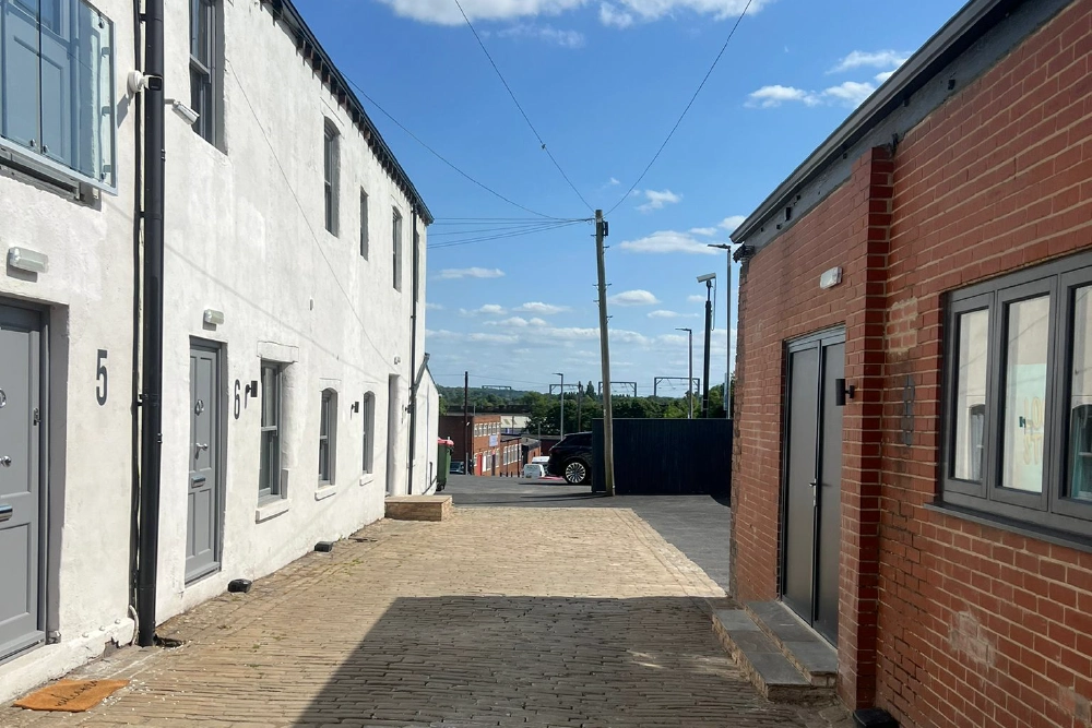 Sunny cobbled courtyard between the commercial units